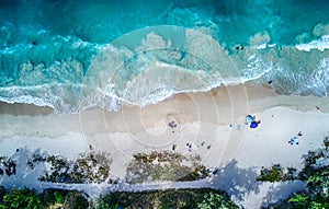 Aerial, top view of the sea and people resting on a sandy beach, Oahu, Hawaii