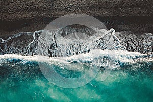Aerial top view of sea waves splashing on the seashore in North Evoia, Greece