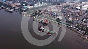 Aerial top view of ships in front of Petroleum`s oil refinery in