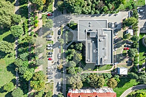 Aerial top view of a small business building among green trees