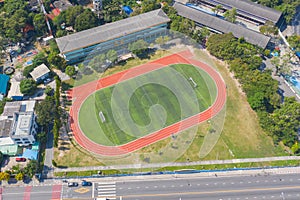 Aerial top view of soccer football sport recreation field ground, national stadium. Urban city town in Asia. Green court arena