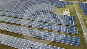 Aerial top view of a solar panels power plant. Photovoltaic solar panels at sunrise and sunset in countryside from above