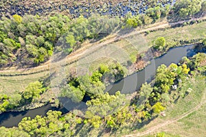 Aerial top view of spring landscape with trees and river