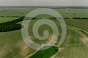 Aerial top view summer day aerial green nature Ukraine. Grass field blue sky white clouds