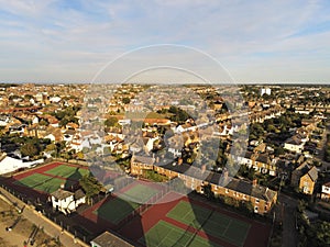 Aerial top view  at tennis courts and private houses in Whitstable, Kent, Uk, England. Evening sunset light on the properties in W