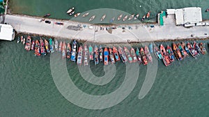 Aerial top view of tour and fishing boats morred on the pier in Pattaya