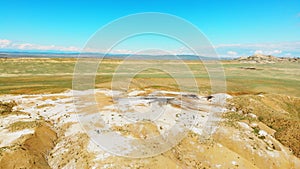 Aerial top view tourist explore mud volcanoes in Chachuna nature reserve with green landscape background in sunny day