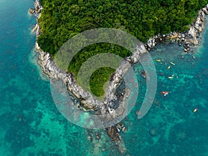 Aerial top view tourists kayaking, swimming and snorkeling in andaman sea at Koh Man island, Phuket, Thailand