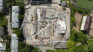 Aerial top view of a tower crane turning its jib