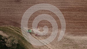Aerial top view of a tractor cultivating farmland in Germany