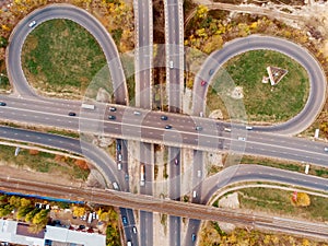 Aerial or top view of transport junction, asphalt roads with crossroad and circle intersections, city traffic cars from above