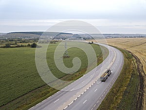 Aerial Top View of Truck with Cargo Semi Trailer Moving on Road in Direction