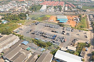 Aerial top view of truck cars parking stock lot row in industry factory, dealer inventory import and export business commercial,