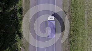 Aerial top view of a truck moving on road. Scene. Concept of transportation, cargo truck moving on highway.