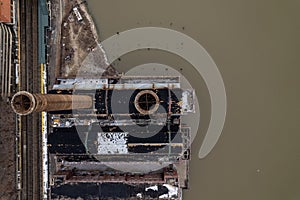 Aerial top view of two rustic industrial chimneys on the Hudson river in New York