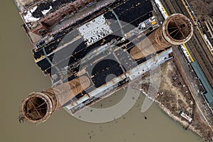 Aerial top view of two rustic industrial chimneys on the Hudson river in New York