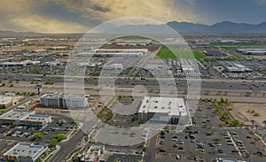 Aerial top view of typical a Avondale small town shopping center with big parking for car on Arizona