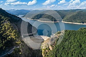 Aerial top view on Vidraru dam, reservoir lake and Fararas mountains, Romania