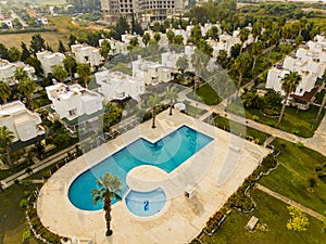 Aerial top view of the villas and a swimming pool at Cenger Beach Resort and SPA hotel in Antalya, Turkey