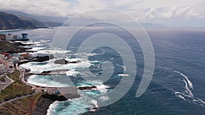 Aerial. Top view waves break on the coastline of Tenerife island