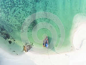 Aerial top view with white sand beah and the local boat near the lagoon seashore