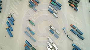 Aerial Top View of White Semi Truck with Cargo Trailer Parking with Other Trucks on Special Parking Lot. Shot on Phantom