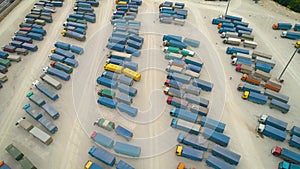 Aerial Top View of White Semi Truck with Cargo Trailer Parking with Other Trucks on Special Parking Lot. Shot on Phantom