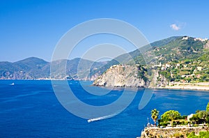 Aerial top view of white yacht sail on water of Ligurian Sea near coastline of Riviera di Levante, National park Cinque Terre Coas