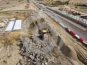 Aerial top view of yellow bulldozer work dig soil f