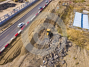 Aerial top view of yellow bulldozer work dig soil f