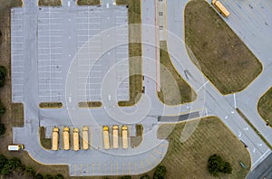 Aerial top view the yellow school buses parked near the high school