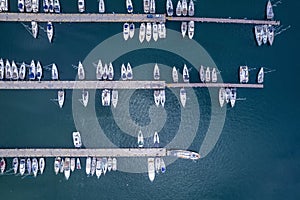 Aerial topdown view to a marina with moored luxury yachts