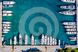 Aerial topdown view to a marina with moored luxury yachts and copy space