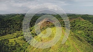 Aerial tourist hiking hill top: green grass mountain peak with traveler at mountain Philippine, Asia