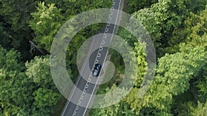 AERIAL Tourists on fun road trip enjoying driving through the scenic countryside