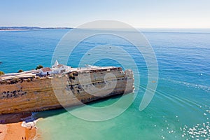 Aerial from the traditional church `Senora de Nossa` at Armacao the Pera in the Algarve Portugal at sunset