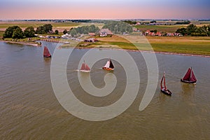 Aerial from traditional dutch wooden boats at the IJsselmeer near the harbor from Laaxum in Friesland the Netherlands at sunset