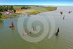 Aerial from traditional dutch wooden boats at the IJsselmeer near the harbor from Laaxum in the Netherlands