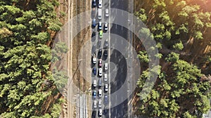 Aerial. Traffic jam with a lot of cars on a highway between forest. Top view