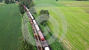 Aerial train shot traveling through a rural area