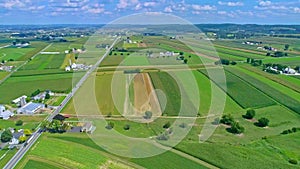 Aerial Traveling View of Corn Fields and Harvesting Crops, With a Train Yard and Patches of Color