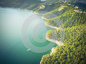 Aerial trees and cliff rock wall crystal water at Lake Travis, A photo