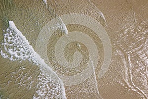 Aerial Tropical beach with small waves and sand