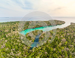Aerial: tropical paradise pristine coast line rainforest blue lake at Bair Island. Indonesia Moluccas archipelago, Kei Islands,