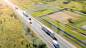 Aerial. Trucks on a highway road. Transport logistic background.