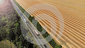 Aerial. Trucks on a highway road. Transport logistics background