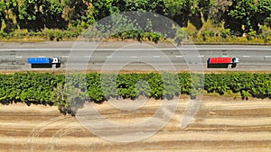 Aerial. Trucks on a highway road. Transport logistics background. Top view