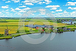 Aerial from a typical dutch landscape with windmills, water en far views