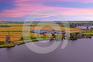 Aerial from a typical dutch landscape with windmills, water en far views