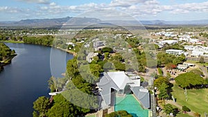 Aerial, unique man-made swimming complex next to river. Location Riverway, Townsville, Australia